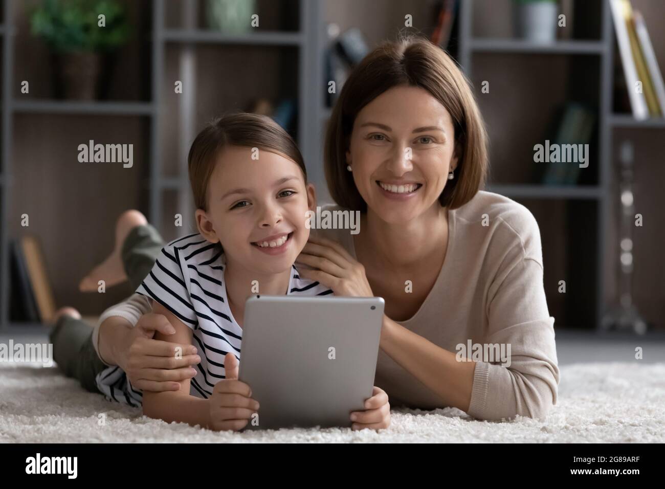 Portrait of happy millennial mom and daughter kid Stock Photo
