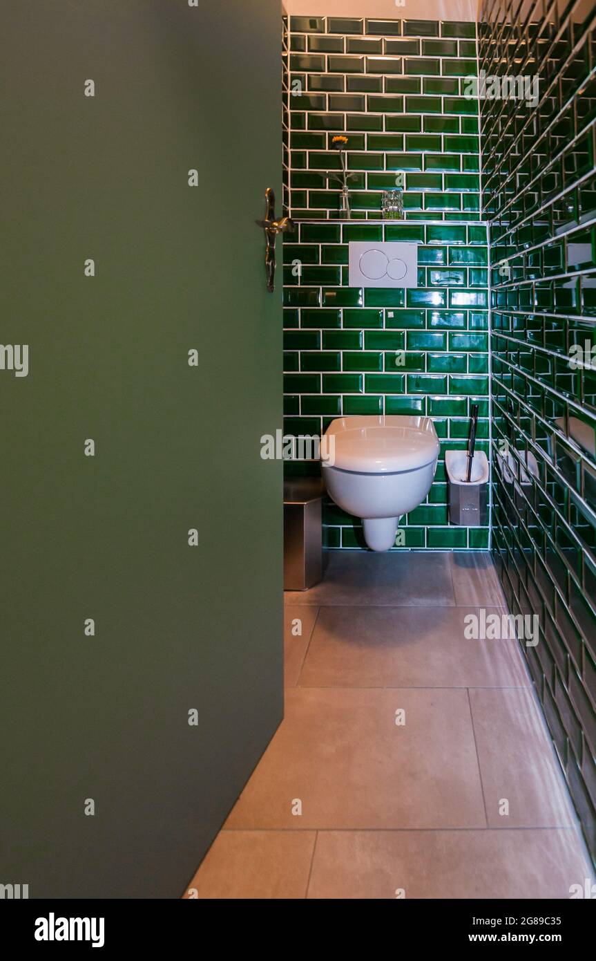 Glance into an extraordinary guest toilet. The small green tiles are particularly noticeable Stock Photo