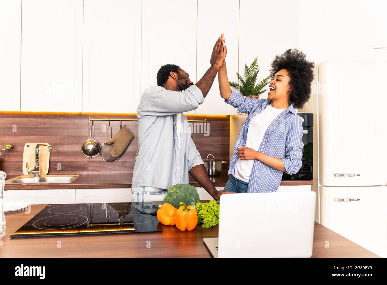 Beautiful afro american couple cooking at home - Beautiful and cheerful ...
