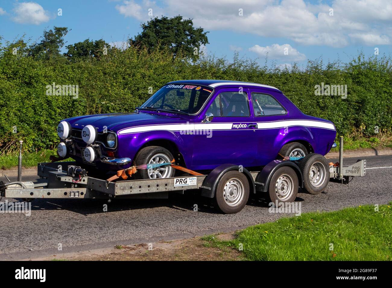 1973 70s purple Ford Escort vehicle on trailer en-route to Capesthorne Hall classic July car show, Cheshire, UK Stock Photo