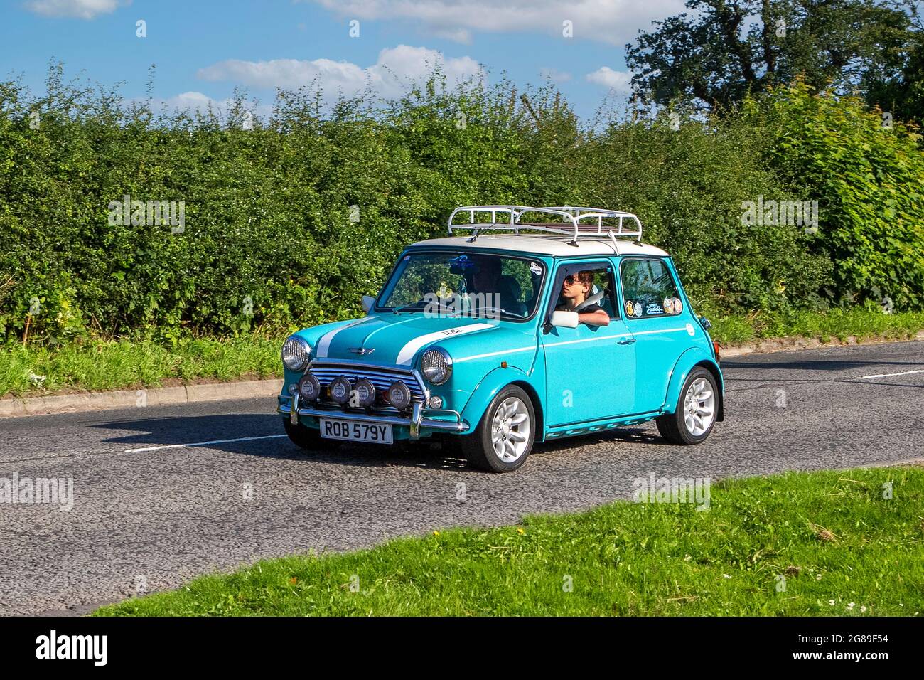 1999 90s Rover blue white Mini-Cooper 1275 cc saloon vehicles en-route to Capesthorne Hall classic July car show, Cheshire, UK Stock Photo