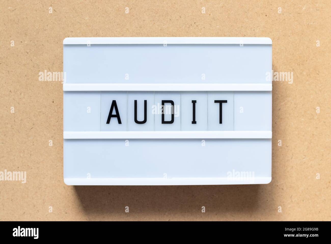 White lightbox with word audit on wood background Stock Photo