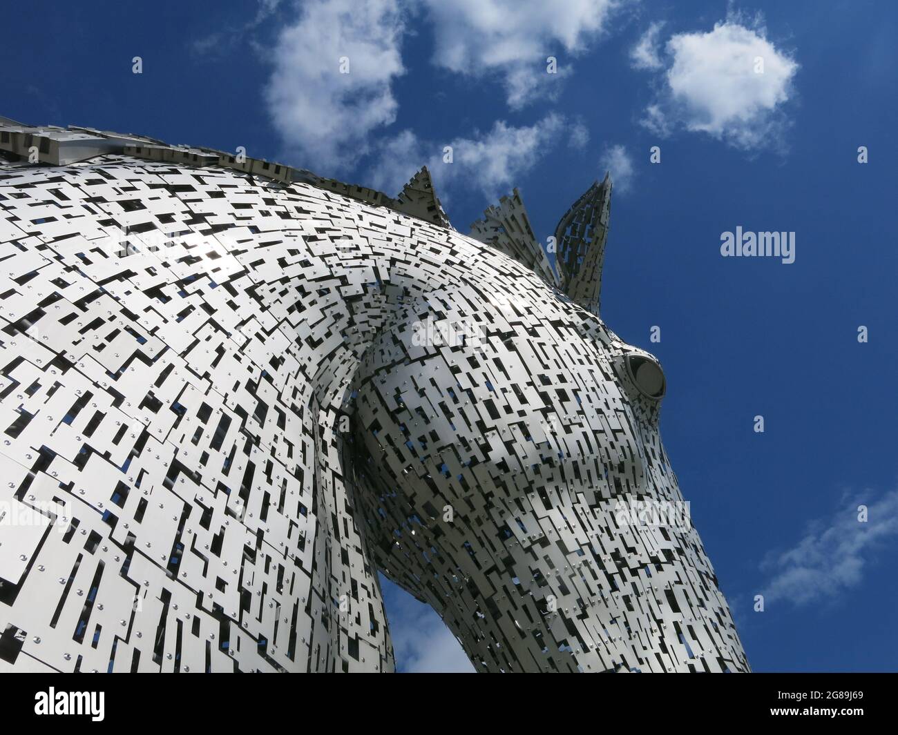 One of the pair of horses heads made from stainless steel panels in Andy Scott's iconic equine sculpture, The Kelpies; a boost for Scottish tourism. Stock Photo