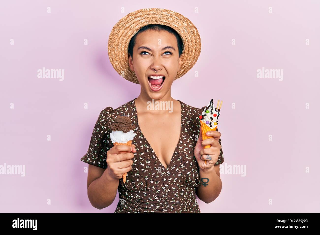 Beautiful hispanic woman with short hair eating ice cream cones angry ...