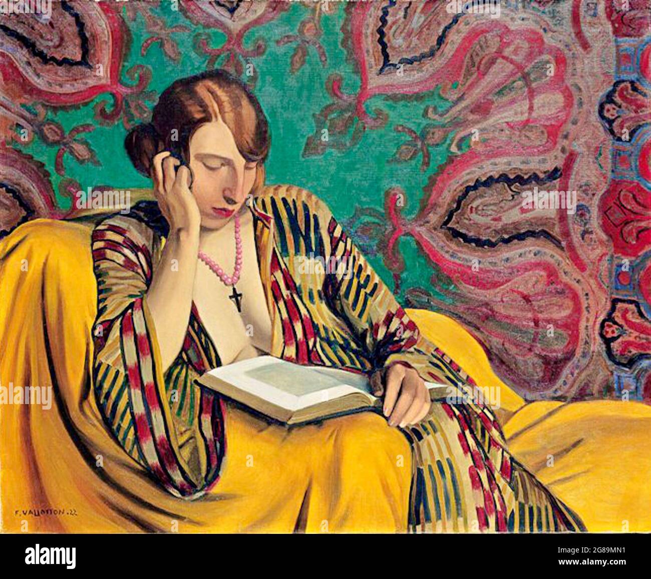 Félix Vallotton artwork entitled La Liseuse or Reading Light. A seated woman reads a book. Ornate mandala style wallpaper adorns the walls. Stock Photo