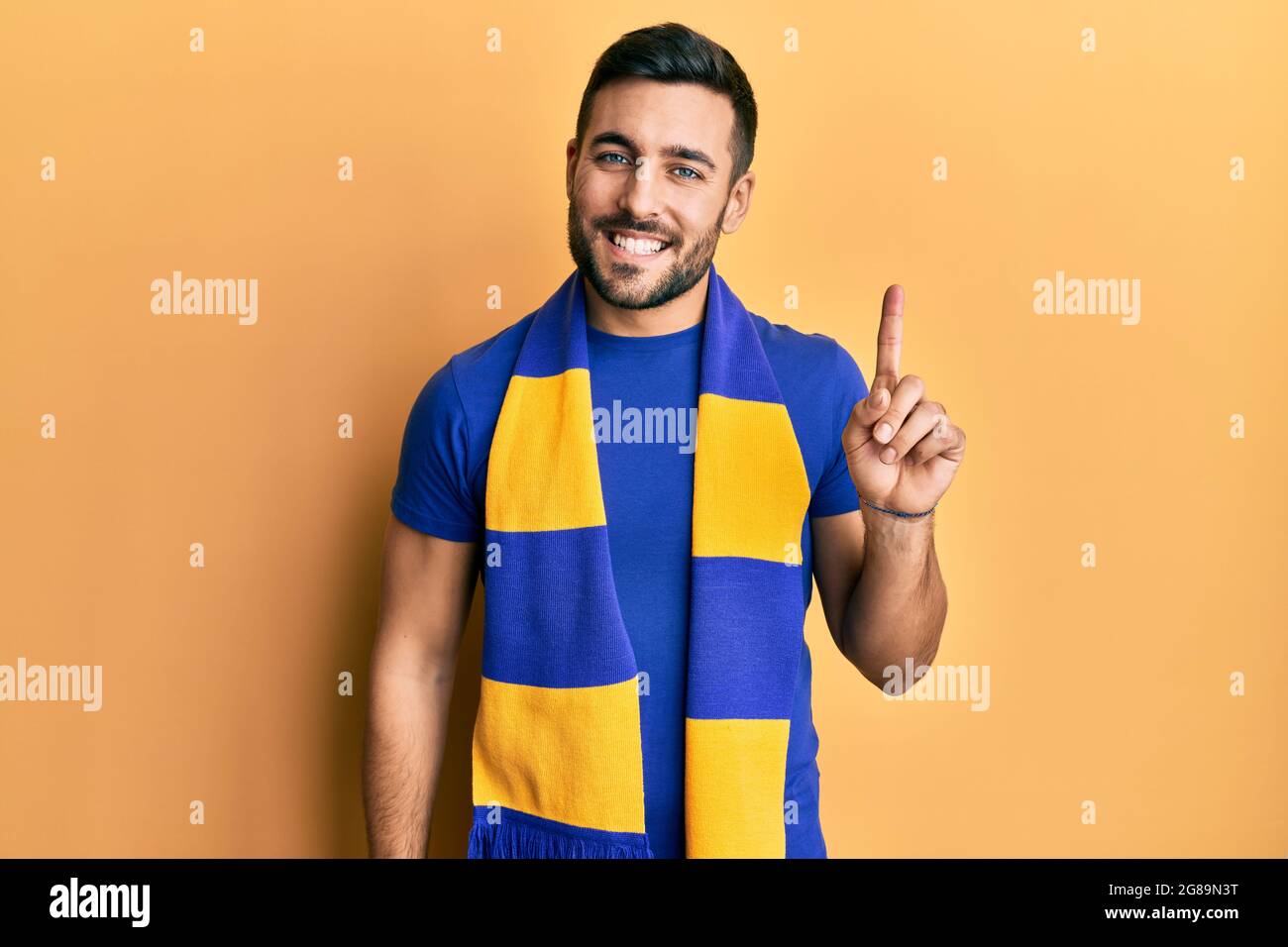 Number One Hooligans Young hispanic man football hooligan cheering game smiling with an idea ...