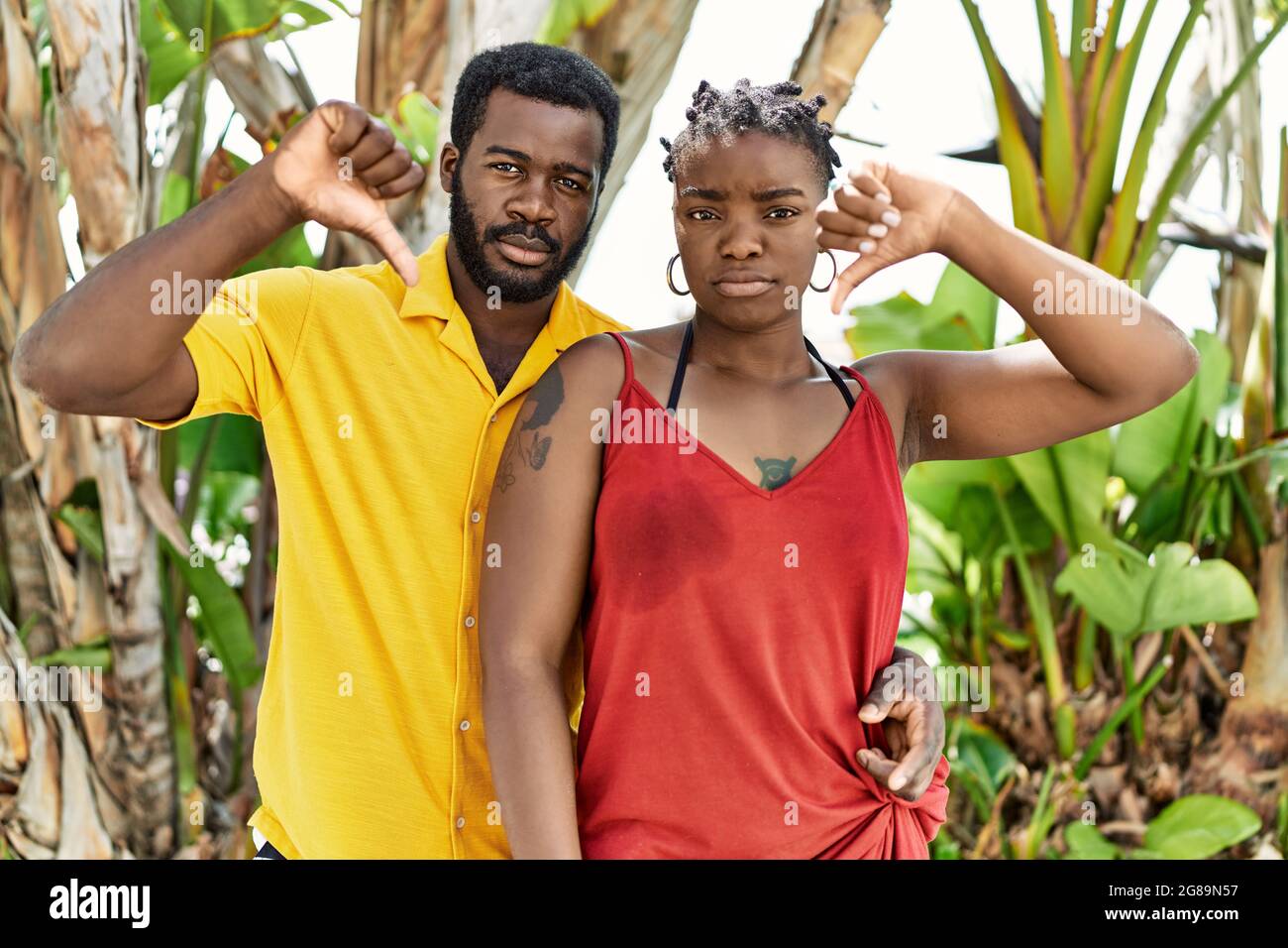 Young african american couple wearing casual clothes standing at the ...