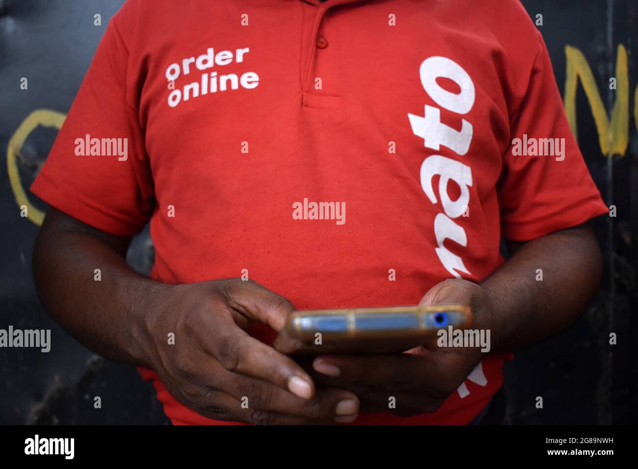 A delivery worker of Zomato, an Indian fooddelivery startup check his