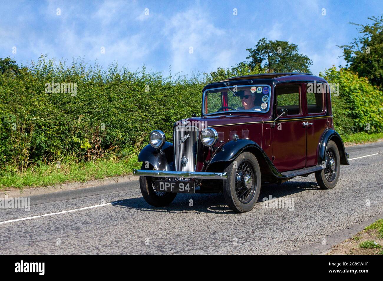 1936 30s pre-war maroon Austin Ten 4dr sedan, 1141cc petrol en-route to Capesthorne Hall classic July car show, Cheshire, UK Stock Photo