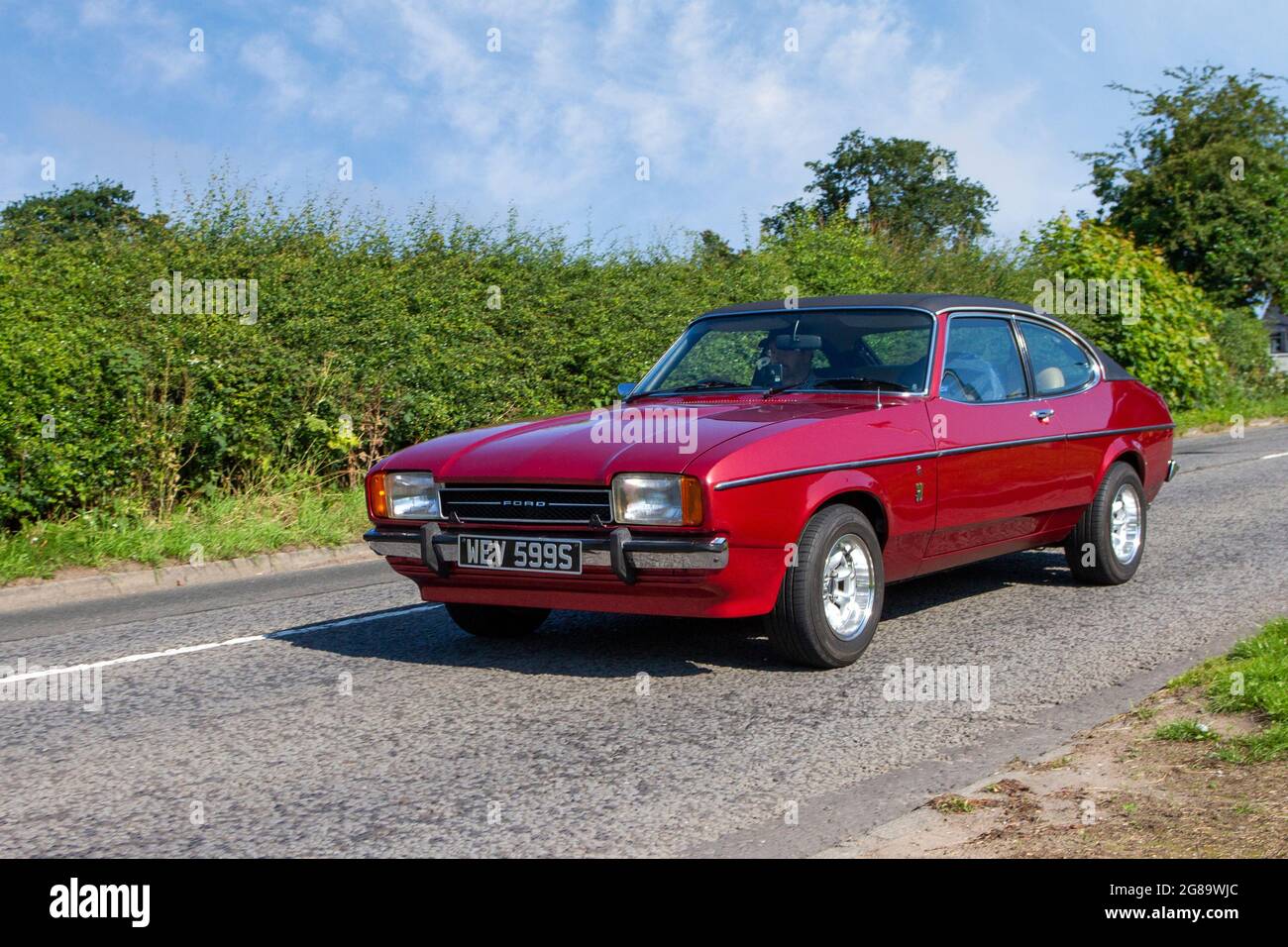 1977 70s seventies Red Ford Capri 2994cc petrol, 2dr coupe en-route to Capesthorne Hall classic July car show, Cheshire, UK Stock Photo