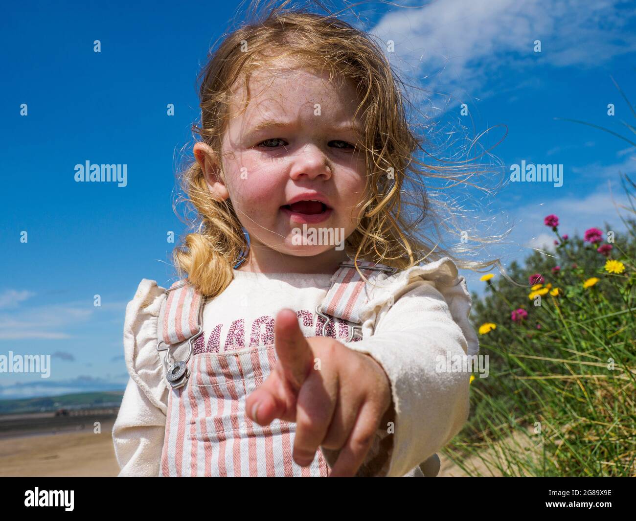 Toddler pointing at the camera, Devon, UK Stock Photo