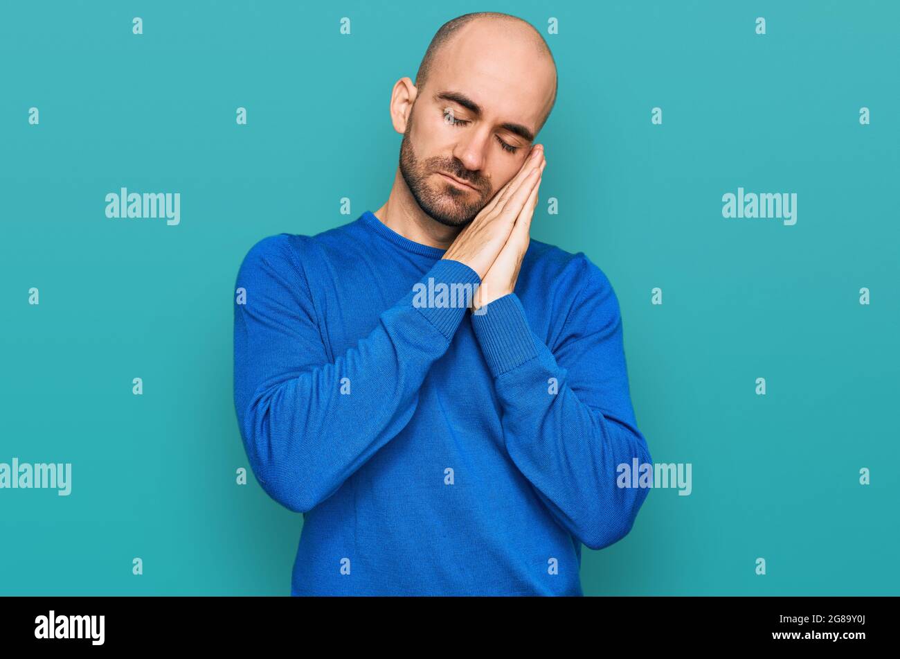 Young hispanic man wearing casual clothes sleeping tired dreaming and ...