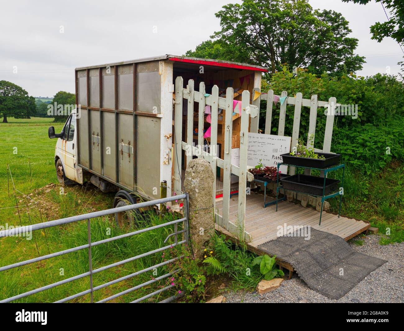 Gem's fresh produce, Fruit, veg, milk and eggs being sold from an old livestock truck at the side of the road, South Trewithey Farm, near North Hill, Stock Photo