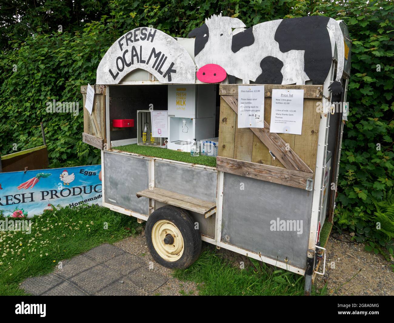 Gem's fresh produce, milk refills being sold from an old trailer at the side of the road, South Trewithey Farm, near North Hill, Cornwall, UK Stock Photo