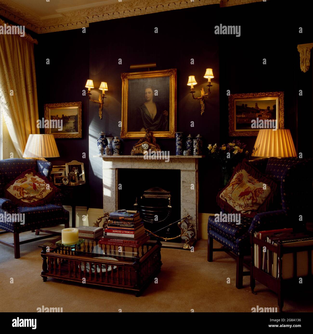 Picture above fireplace in traditional navy blue townhouse living room  Stock Photo - Alamy, image size:1300x1387