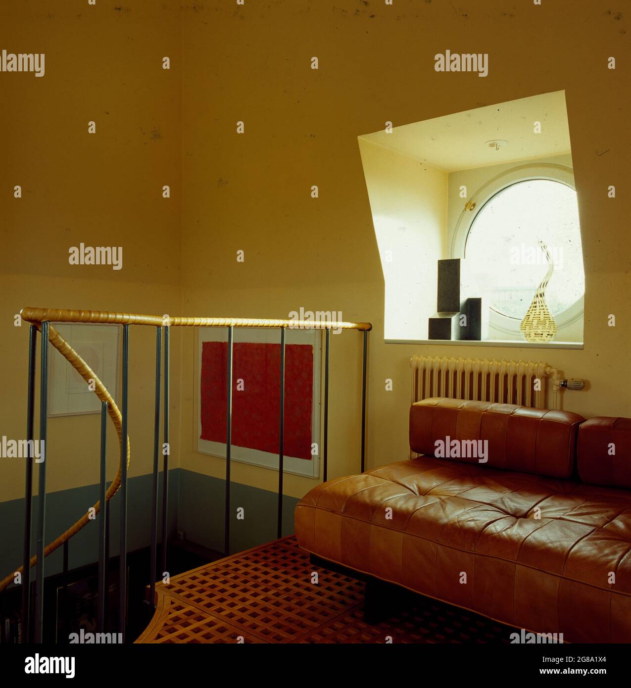 Attic room with round window and radiator cover Stock Photo - Alamy