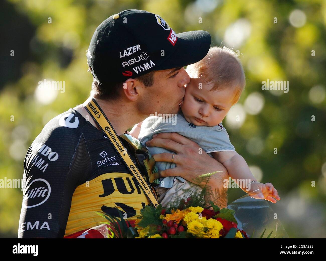 Cycling - Tour de France - Stage 21 - Chatou to Paris Champs-Elysees -  France - July 18, 2021 Team Jumbo–Visma rider Wout van Aert of Belgium  holds a baby as he