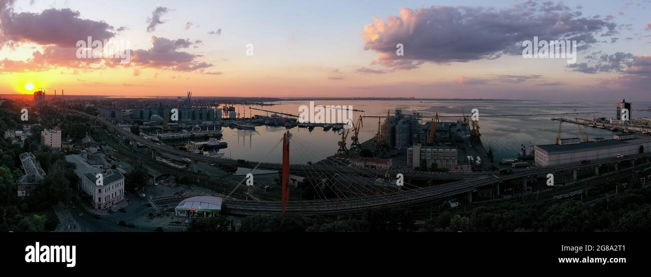 Sun set panorama of urbane landscape with sea por in Odessa Ukraine. Drone footage, natural light. Stock Photo