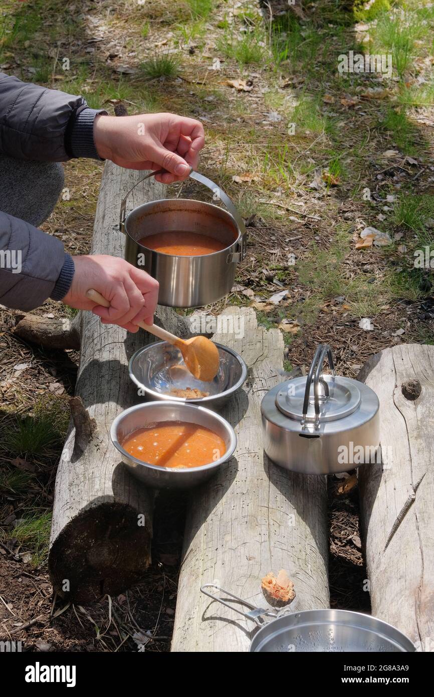 Journey food for outdoor activities and picnic. Food in bowls in the forest. Camping food making. Stock Photo