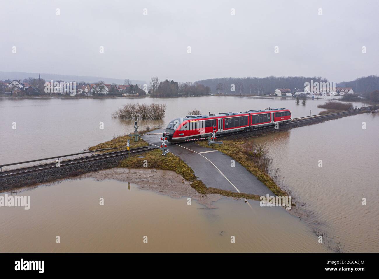 Flooding Germany .Flooded road passing through the railway. A road under water. Germany 2021  Stock Photo