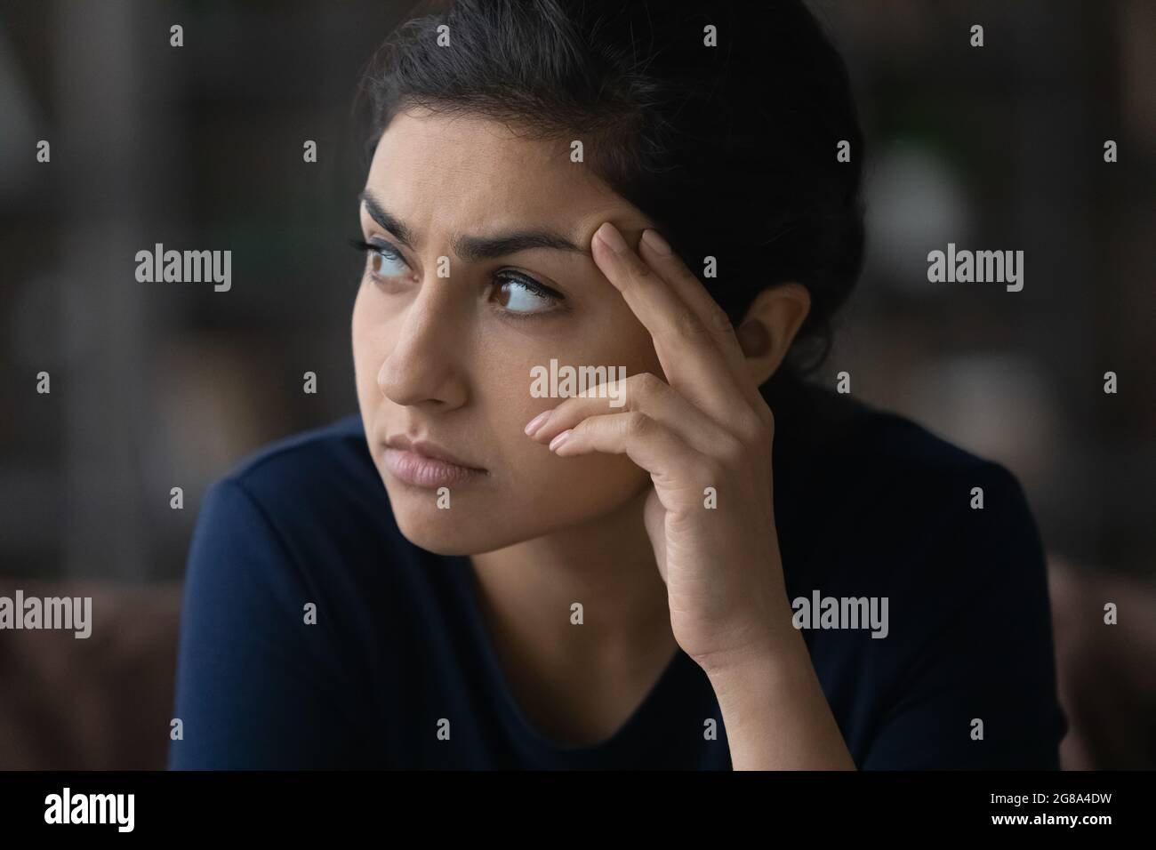 Pensive Indian woman look in distance thinking Stock Photo - Alamy