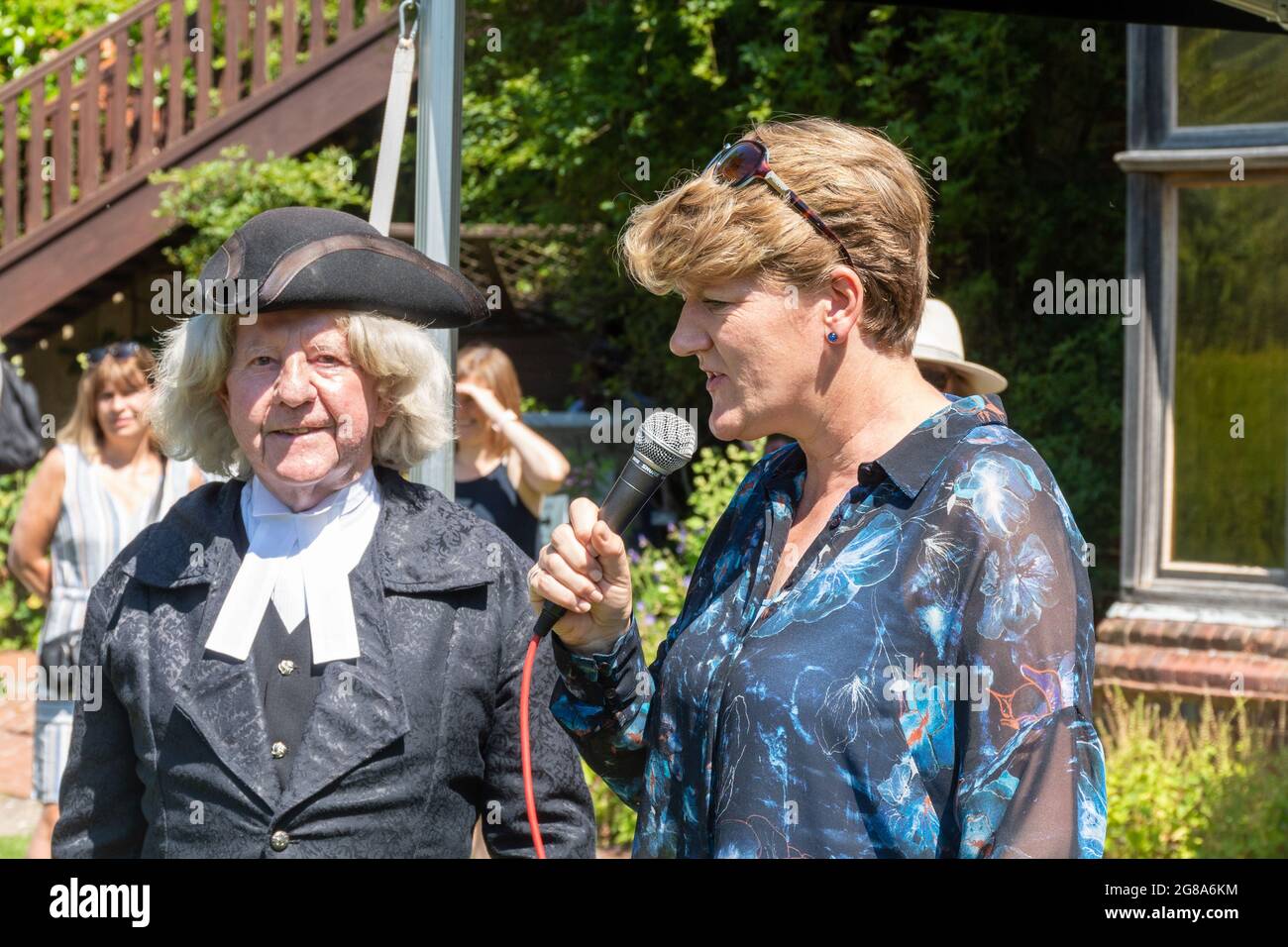 July 18th, 2021. Presenter Clare Balding wishing a Gilbert White lookalike Happy Birthday at the 301st Birthday Party event for the famous naturalist in the garden of the Gilbert White House and Museum in Selborne, Hamphire, England, UK. This event had been delayed a year due to the covid-19 pandemic. Stock Photo
