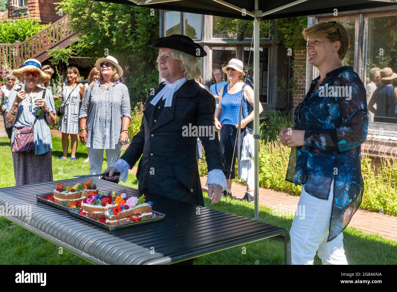 July 18th, 2021. Presenter Clare Balding wishing a Gilbert White lookalike Happy Birthday at the 301st Birthday Party event for the famous naturalist in the garden of the Gilbert White House and Museum in Selborne, Hamphire, England, UK. This event had been delayed a year due to the covid-19 pandemic. Stock Photo