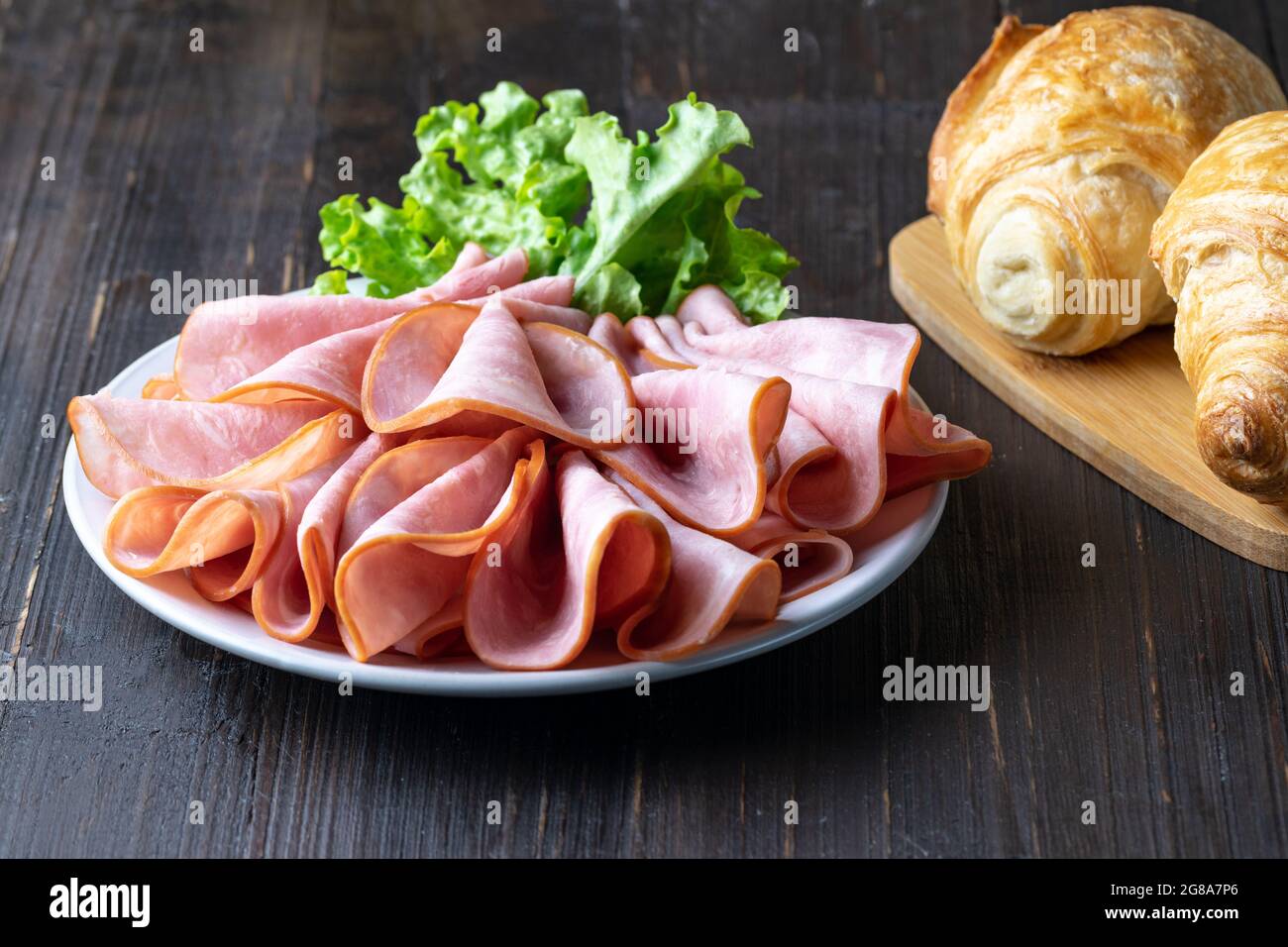 A closeup shot of ham served on a plate with salad leave Stock Photo ...