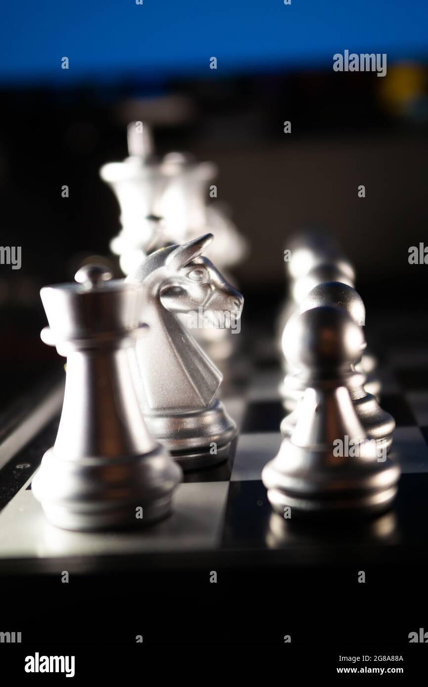 Horizontal shot of cool silver chess pieces in the starting position  reflected on the board Stock Photo by wirestock