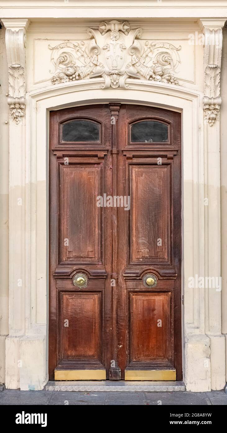 Paris, ancient wooden door, typical building in the 10e arrondissement, rue de Marseille Stock Photo
