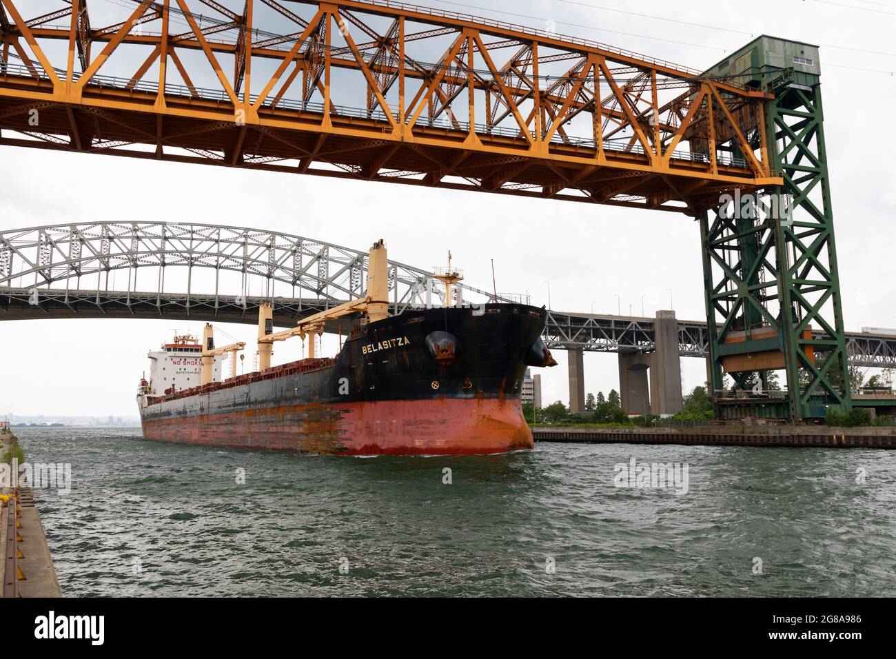 Freight ship passing under Burlington Canal Lift Bridge and Burlington