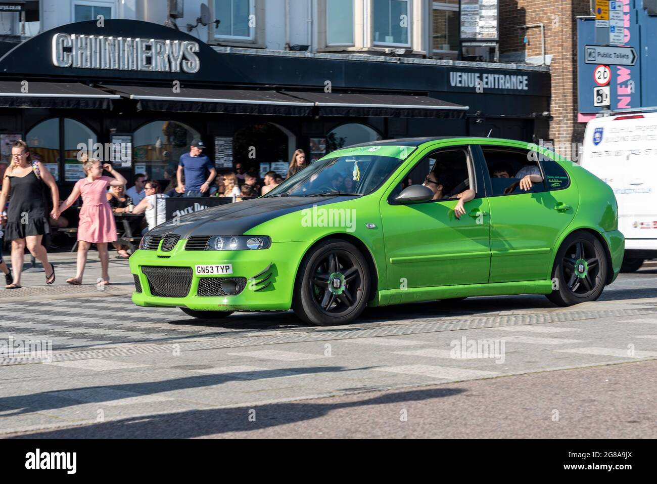 SEAT Leon custom car driving past cafes and amusement arcades on Marine Parade, Southend on Sea, Essex, UK. Lowered, modified. Teens cruising Stock Photo