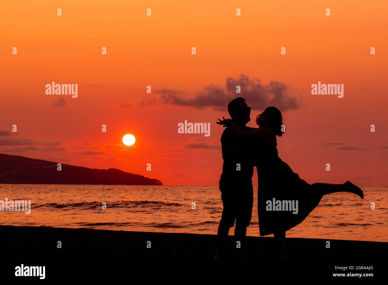 Couple embracing at beach, silhouette in sunset, love and friendship ...