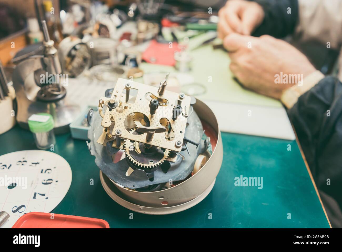 Close up on clockwork of clock to be repaired in watchmaker workshop Stock Photo