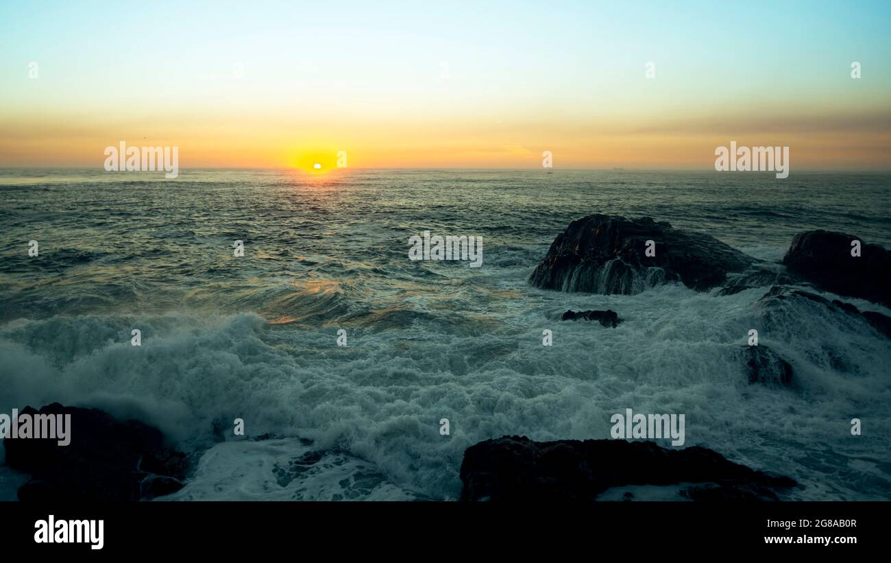 View of the ocean surf during a stunning sunset. Stock Photo