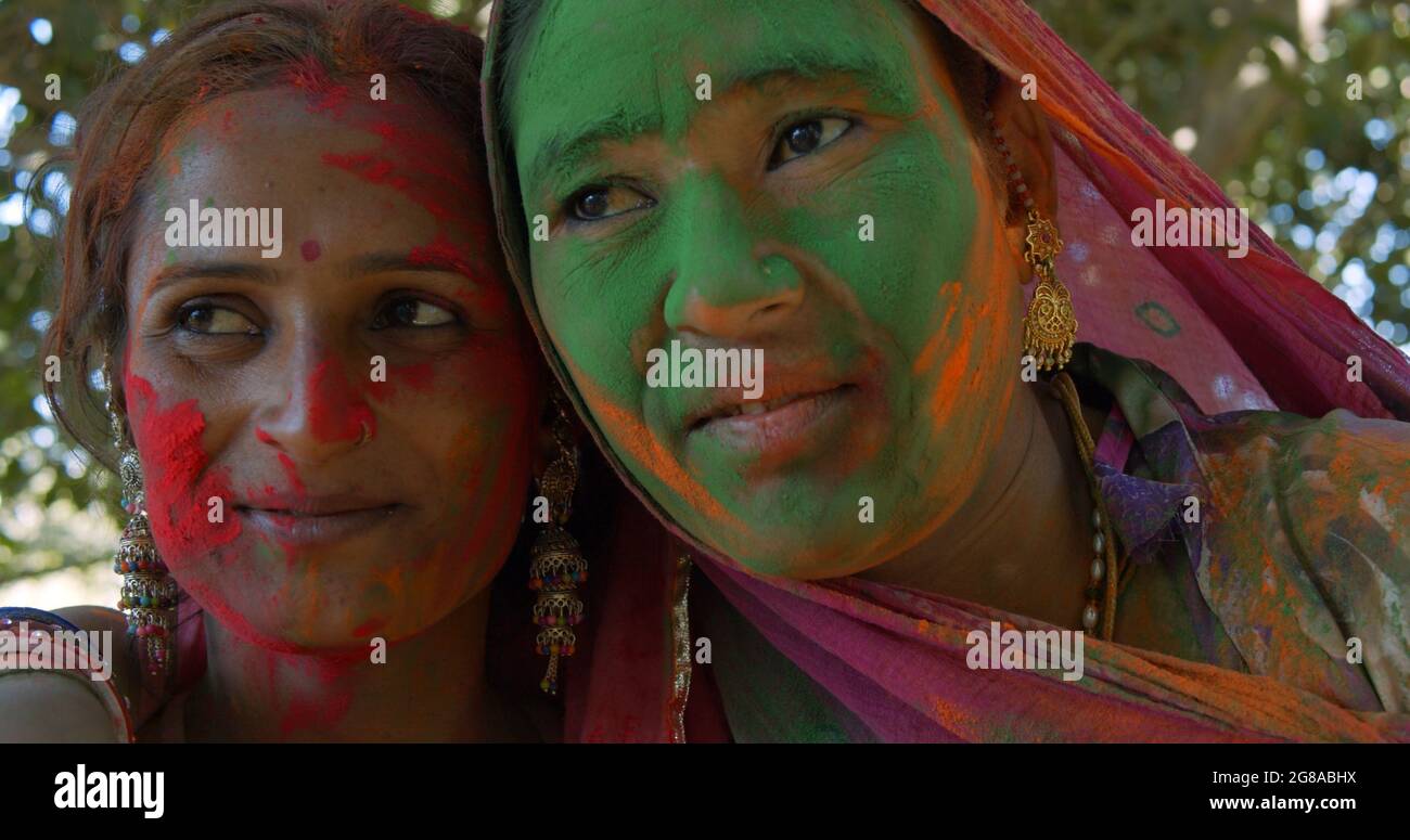 A headshot of Indian women with painted faces; the Festival of Colors ...