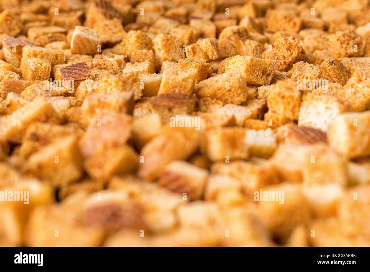 Squareshaped bread crumbs. Ovenfried golden brown bread crumbs. Background Stock Photo Alamy