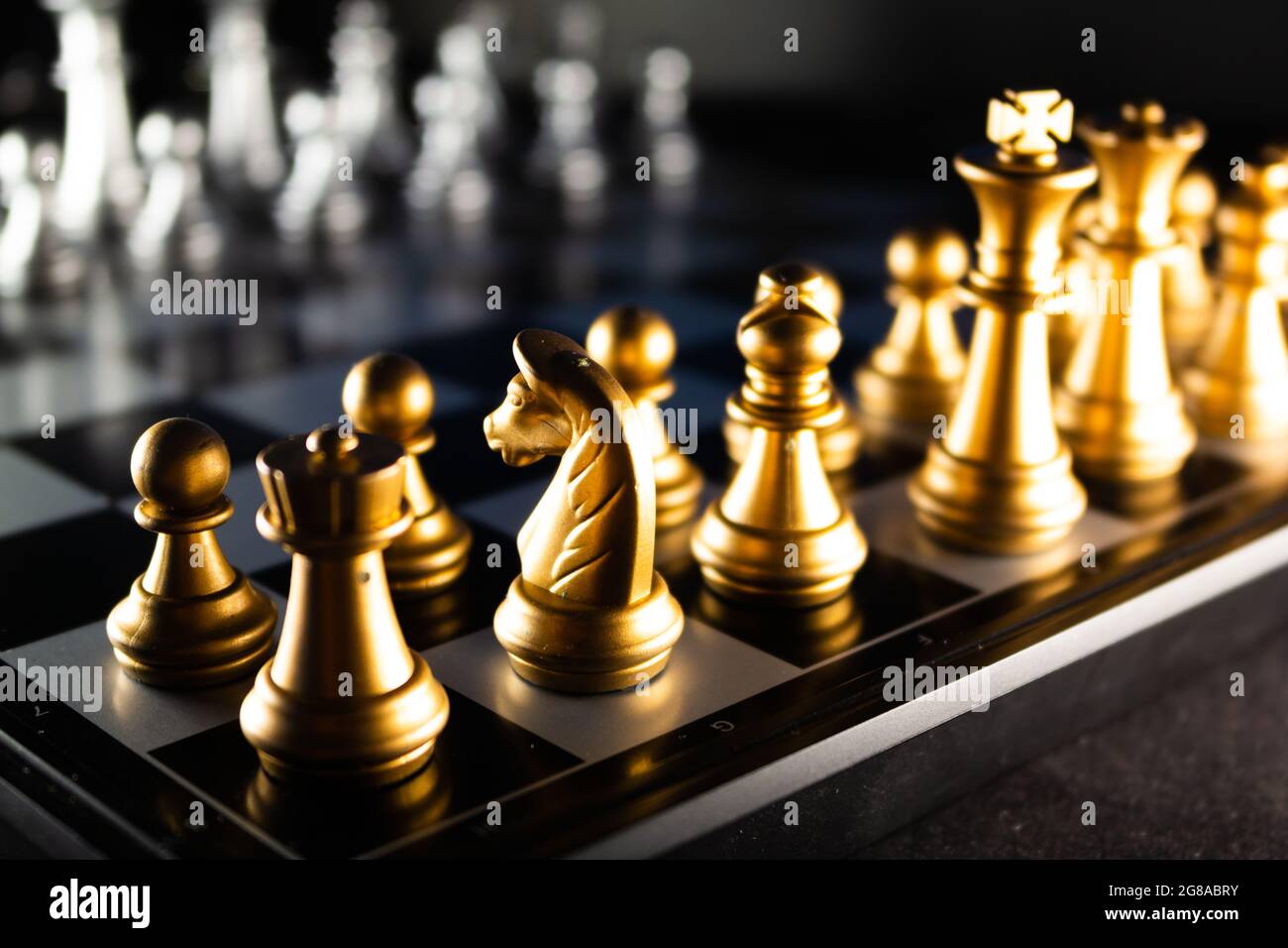 Horizontal shot of cool silver chess pieces in the starting position  reflected on the board Stock Photo by wirestock