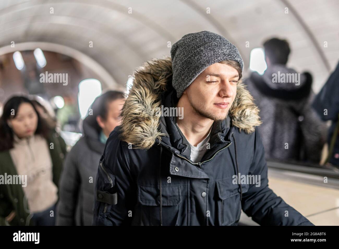 young man on the escalator in subway Stock Photo