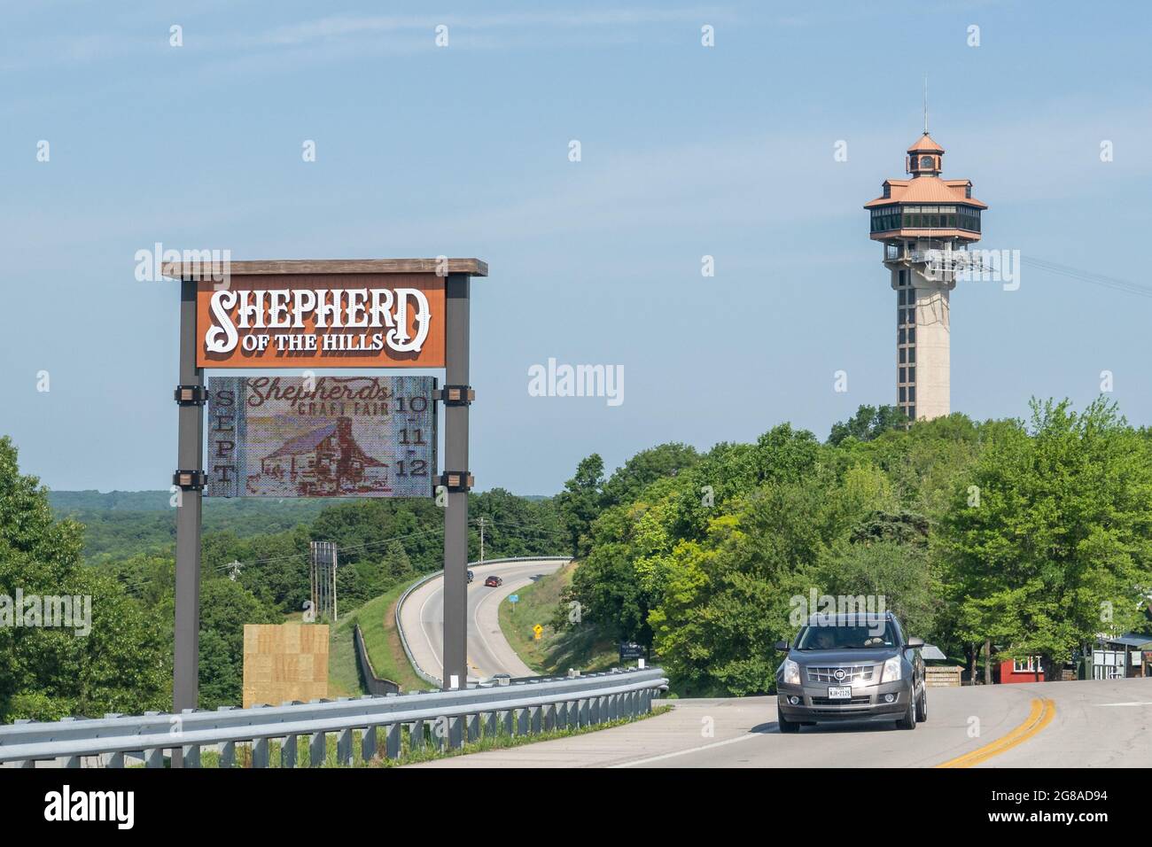 Branson, MO June 12, 2021 Sign for Shepherd of the Hills, with Inspiration Tower in the