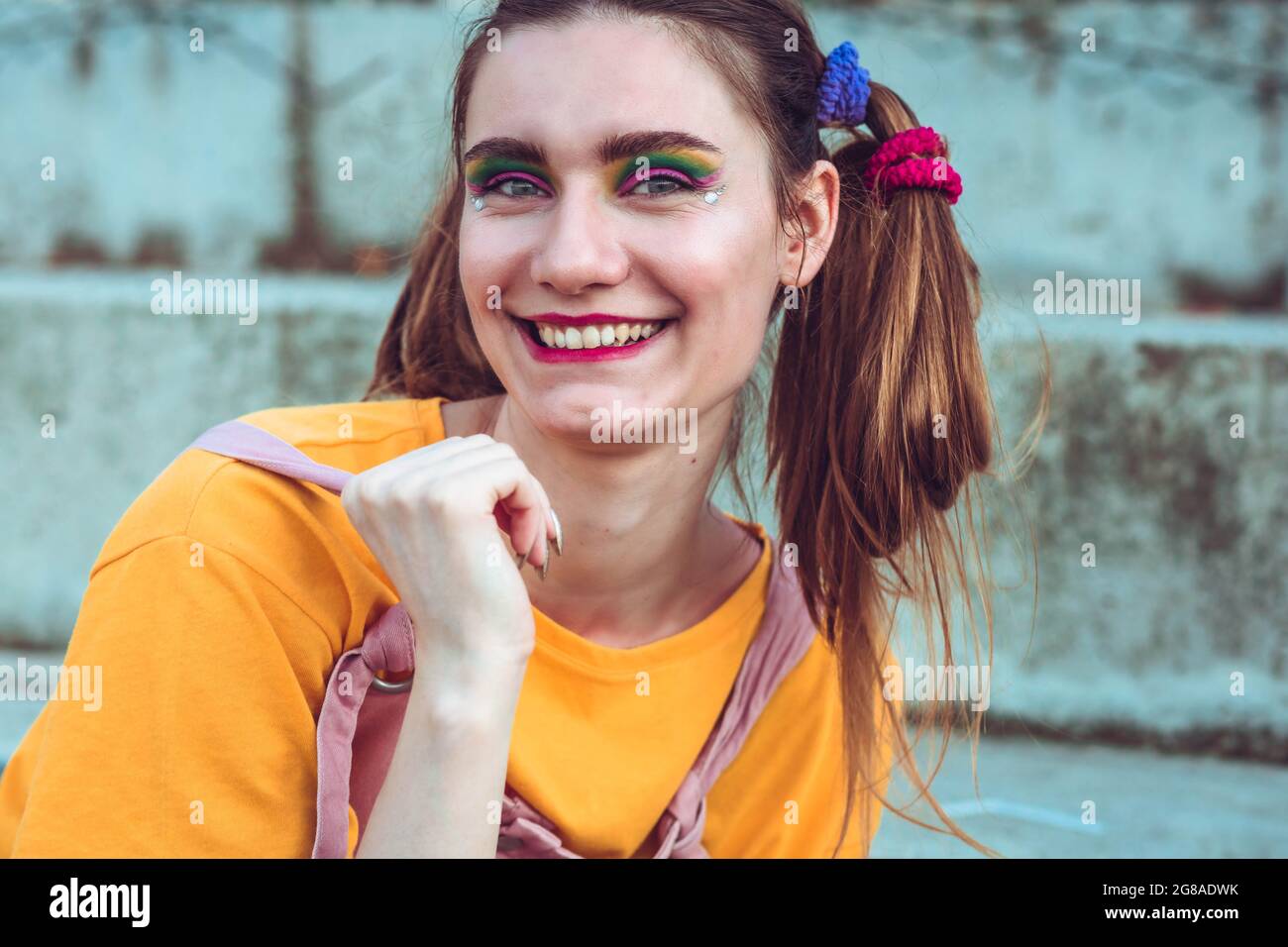 Portrait of a young, blonde girl with pigtails. Strong make up Stock Photo