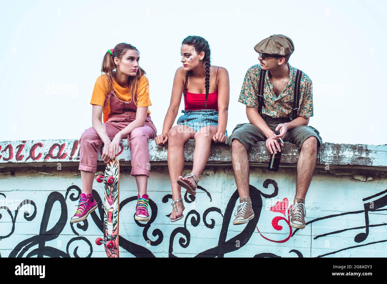 Group of friends hanging out outside. Chilling Stock Photo