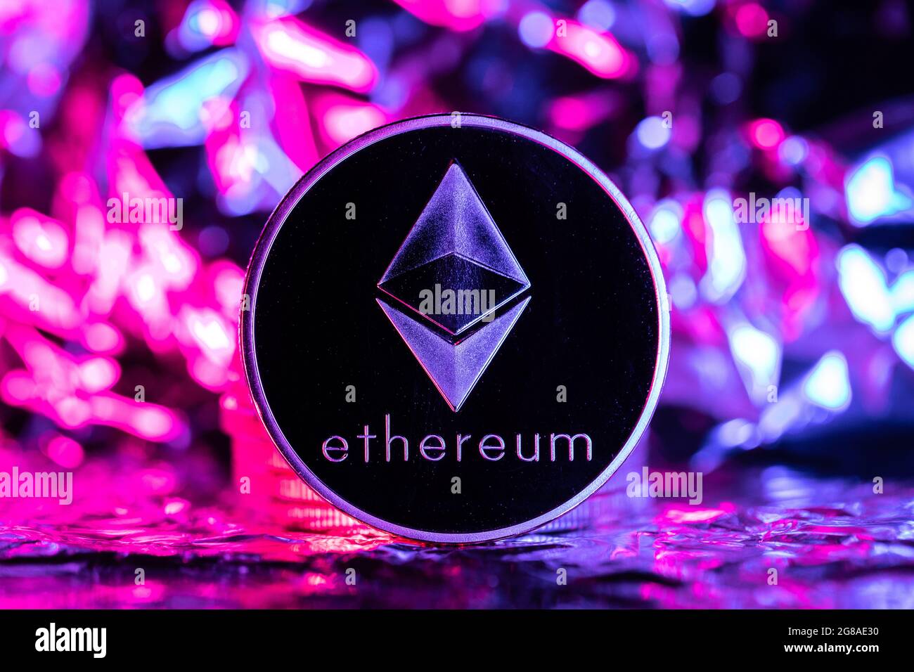 Ethereum cryptocurrency, physical coin in front of an abstract background  Stock Photo - Alamy