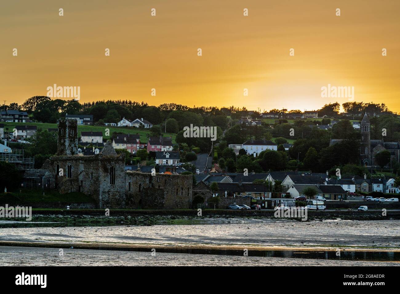 Timoleague, West Cork, Ireland. 18th July, 2021. The sun sets spectacularly over the Fransiscan Friary in Timoleague on the hottest day of the year so far. The high temperatures are expected to continue all week before the weather breaks on Friday. Credit: AG News/Alamy Live News Stock Photo