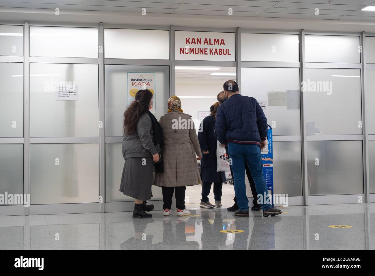 Beyoglu, Istanbul, Turkey - 02.17.2021: people waiting in front of door of blood test room in Taksim Training and Research Hospital in pandemia days w Stock Photo