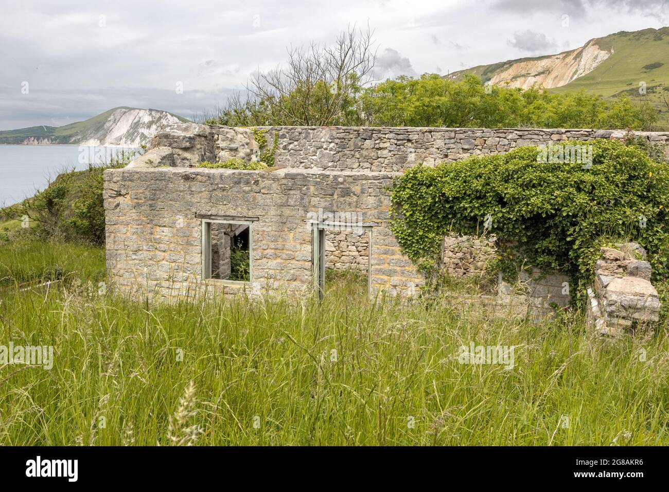 Worbarrow Bay and Mupe Rocks behind a ruined house, Jurassic coast, Dorset, UK Stock Photo