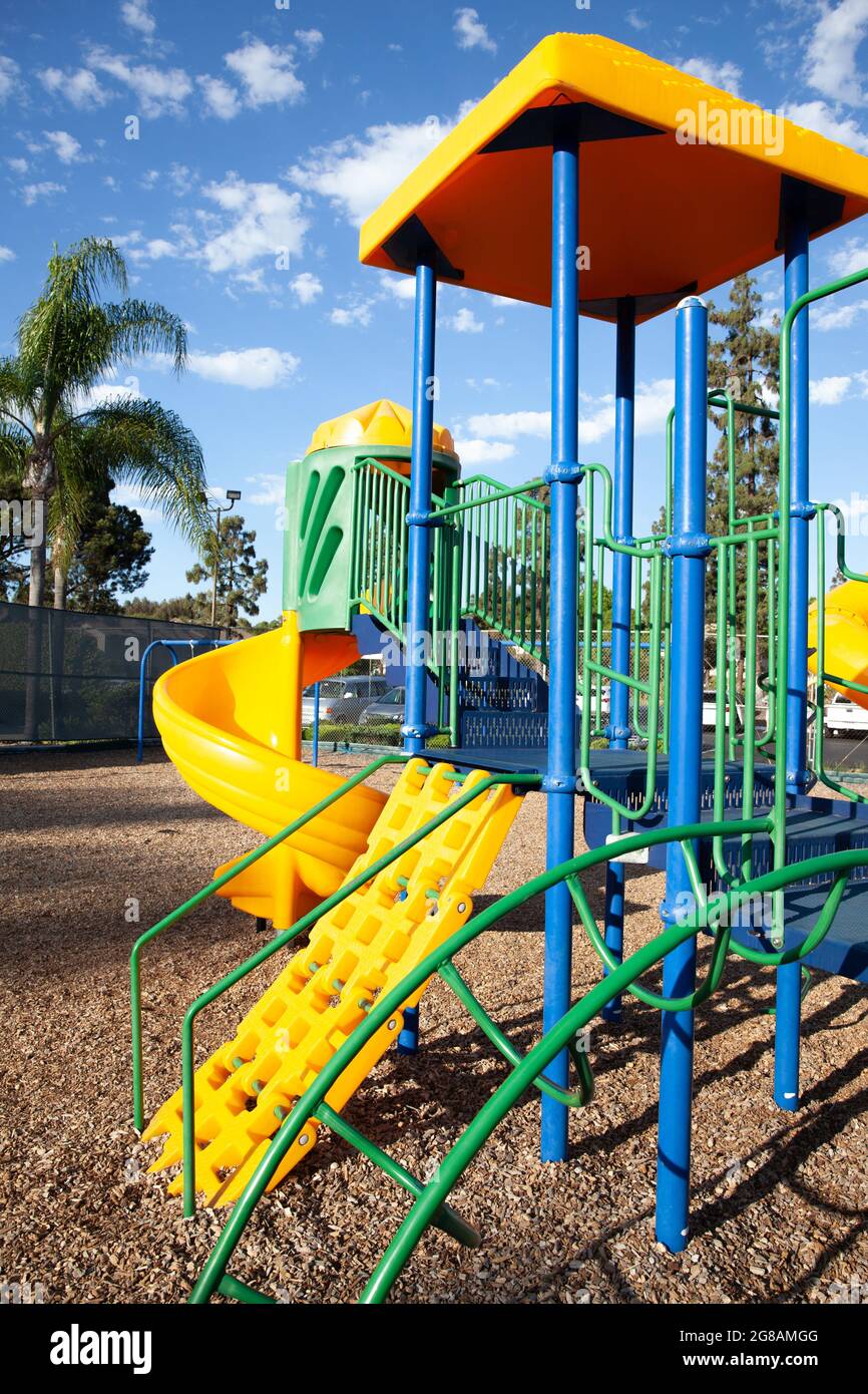 Modern colorful kids playground - swings, slides, steps and ladders. Outdoor plastic playing area for children. Stock Photo