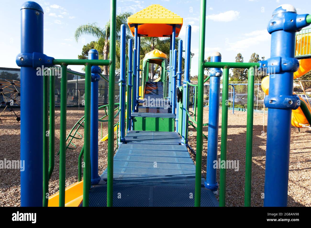 Modern colorful kids playground - swings, slides, steps and ladders. Outdoor plastic playing area for children. Stock Photo