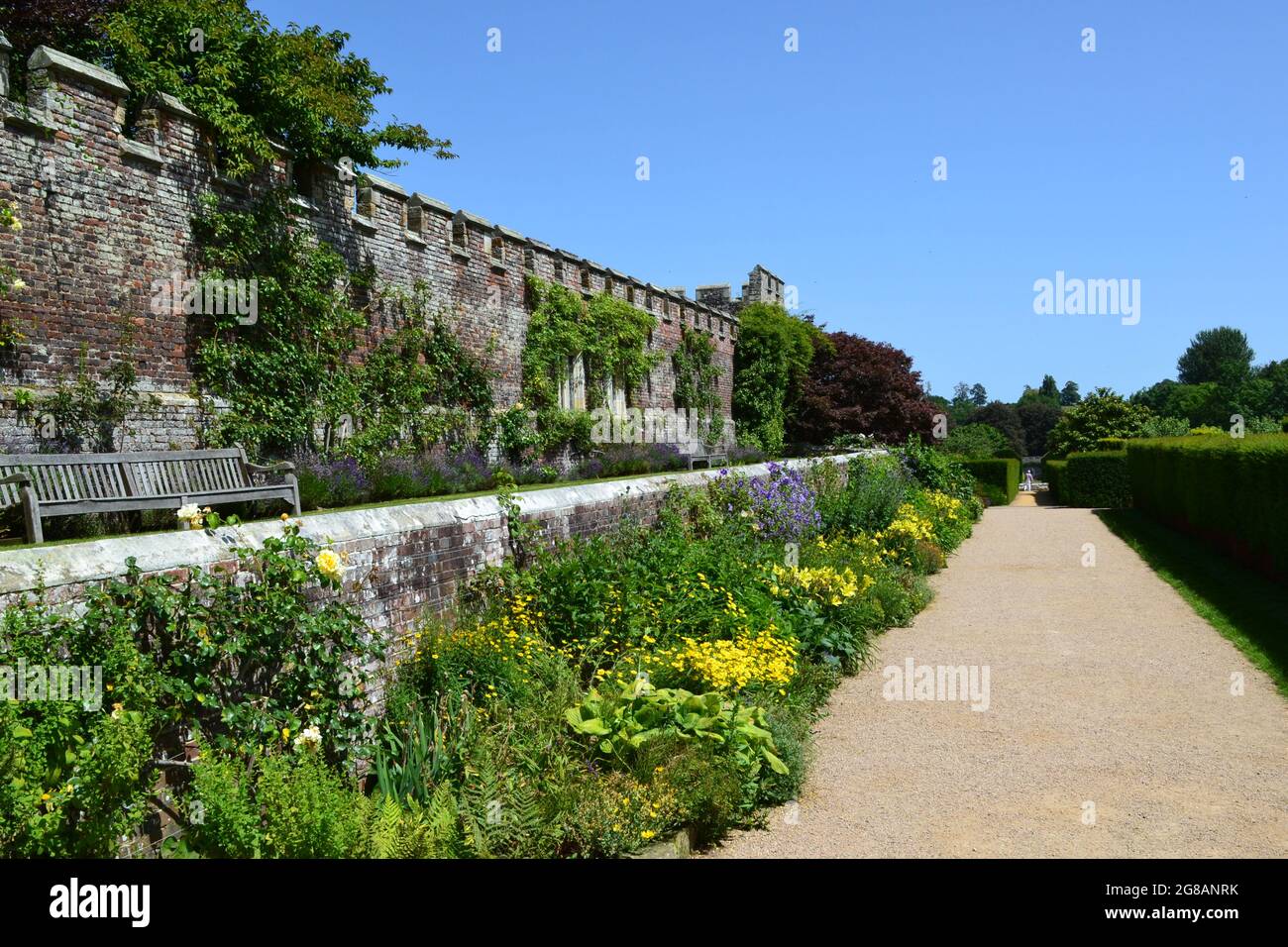 Flower beds, borders, Tudor crenellated wall, and flowers at Penshurst