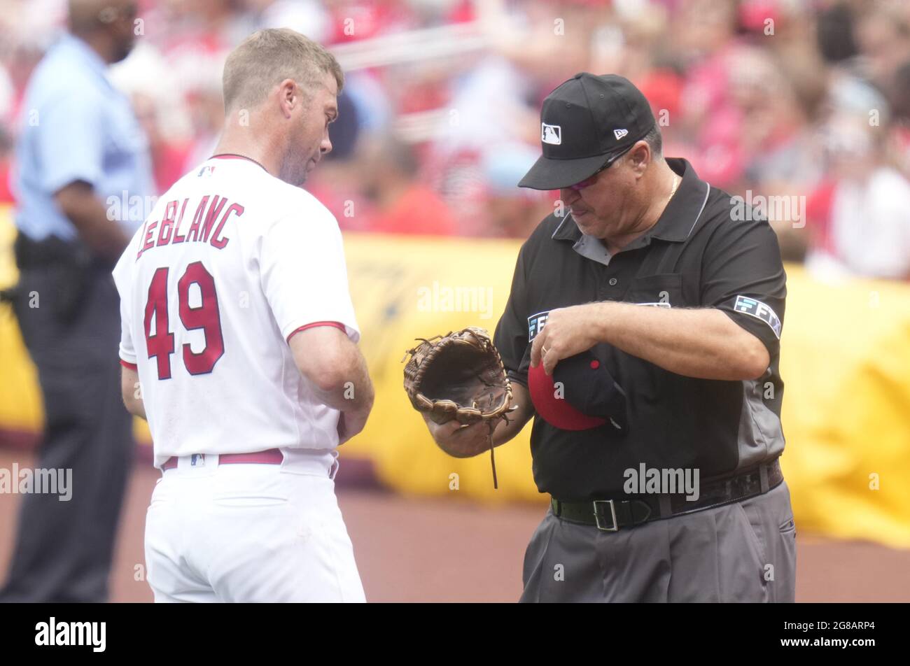 St. Louis, United States. 18th July, 2021. First base umpire Tony Randazzo checks the cap and glove of St. Louis Cardinals starting pitcher Wade LeBlanc in the fifth inning against the San Francisco Giants at Busch Stadium in St. Louis on Sunday, July 18, 2021. Photo by Bill Greenblatt/UPI Credit: UPI/Alamy Live News Stock Photo
